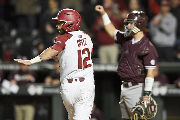 Arkansas catcher Casey Opitz runs to home plate to score a run during the sixth inning of a game against Mississippi State on Thursday, April 18, 2019, in Fayetteville. 