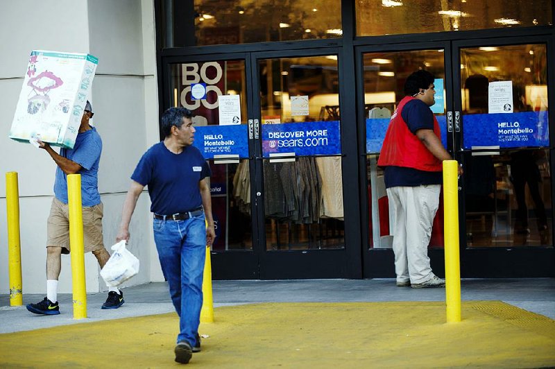 Shoppers leave a Sears store last fall in Montebello, Calif. Sears Holdings Corp. has filed a lawsuit against its former chairman and CEO, Edward Lampert, and his hedge fund. 