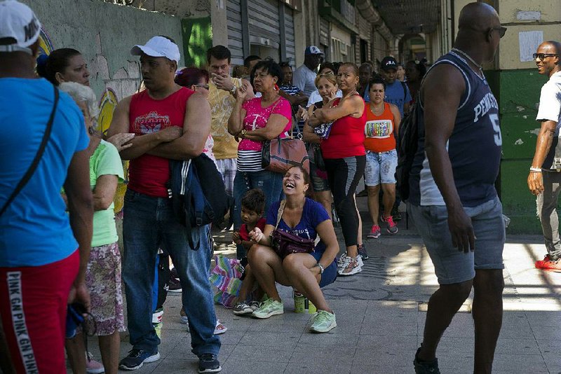 People wait in line to buy chicken Wednesday at a government-run grocery store in Havana, which is experiencing food shortages. 