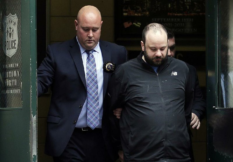 A police officer escorts Marc Lamparello out of a police precinct Thursday in New York after his arrest on attempted arson and reckless endangerment charges. 