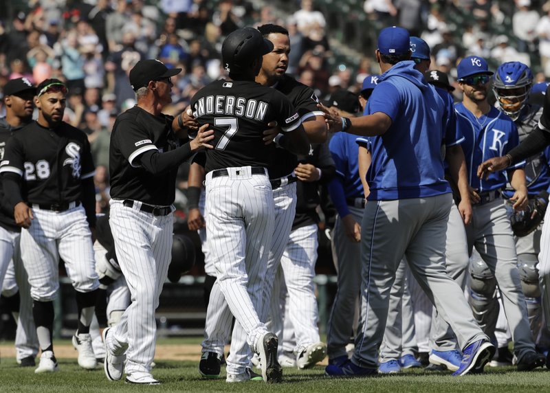 The Associated Press HOLD ME BACK: Chicago White Sox's Tim Anderson (7) is restrained by Jose Abreu after he was hit by a pitch from the Kansas City Royals, as benches cleared during the sixth inning of Wednesday's game in Chicago. The Royals won 4-3 in 10 innings.