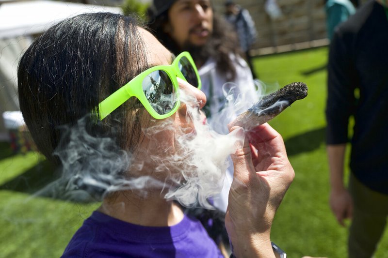 In this Friday, March 22, 2019 file photo, a participant takes a very smoky puff from a marijuana cigarette during at meet and greet at "Tommy Chong's Live, Love, and Smoke Tour hosted by GreenTours in the Woodland Hills section of Los Angeles. U.S. retail sales of cannabis products jumped to $10.5 billion last year, a threefold increase from 2017, according to data from Arcview Group, a cannabis investment and market research firm. The figures do not include retail sales of hemp-derived CBD products. (AP Photo/Richard Vogel, File)