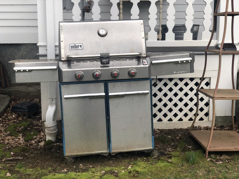 In this April 14 photo, a grill sits outside a home in New Milford, Conn., in need of some upkeep after sitting unused during the winter months. (Katie Workman via AP) 

