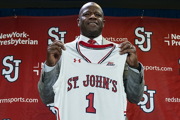 Mike Anderson holds up a jersey after being introduced as the new St. John's men's basketball coach during a news conference, Friday, April 19, 2019, at Madison Square Garden in New York. Anderson was hired as Red Storm coach on Friday after he was fired by Arkansas in March. (Craig Ruttle/Newsday via AP)

