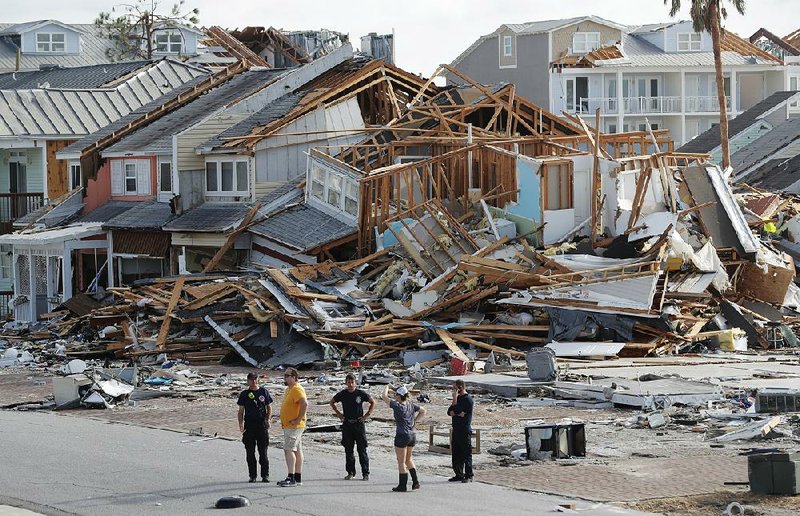 Rescuers on Oct. 11 in Mexico Beach, Fla., comb the wreckage left behind by Hurricane Michael. 