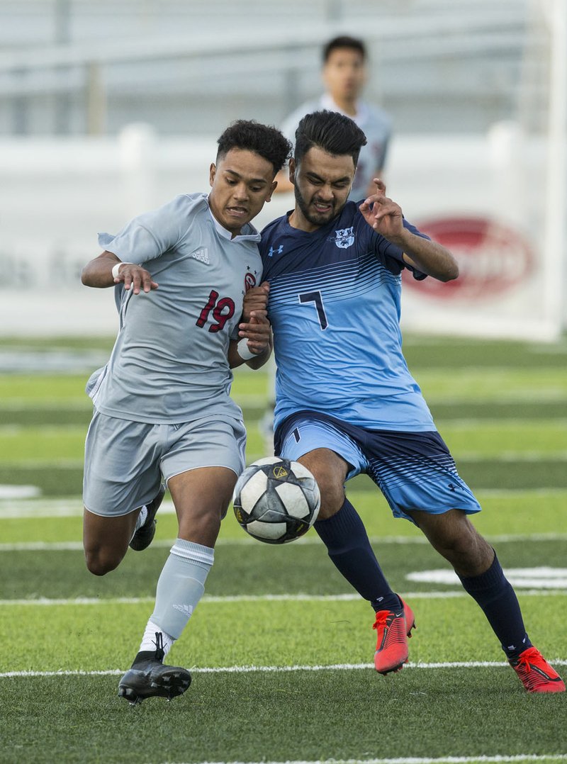 NWA Democrat-Gazette/BEN GOFF @NWABENGOFF Irvin Sotero (19) of Springdale battles for the ball vs Esteban Fuentes (7) of Springdale Har-Ber in the first half Friday, April 19, 2019, at Har-Ber's Wildcat Stadium in Springdale.