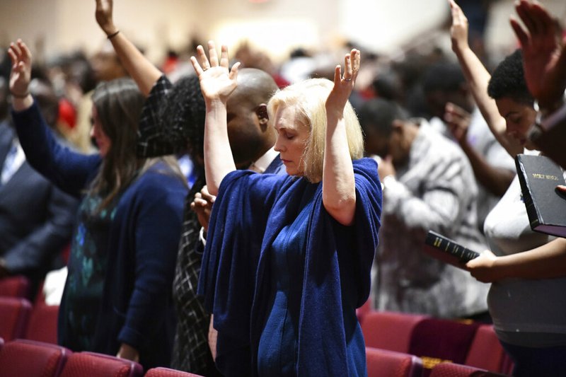 In this Feb. 10, 2019, file photo, Sen. Kirsten Gillibrand, D-N.Y., worships at Mount Moriah Missionary Baptist Church in North Charleston, S.C. By now, most Democratic presidential candidates have polished their stump speeches. But when they're in South Carolina, they may need to add in a sermon. In a large and diverse primary field, White House hopefuls are angling to develop relationships with black churches. (AP Photo/Meg Kinnard, File)