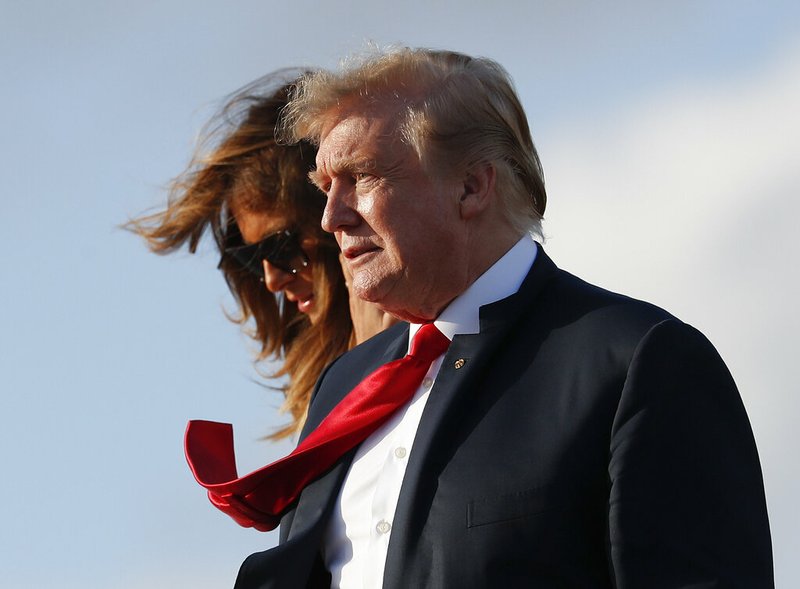 President Donald Trump and first lady Melania Trump, walk down the stairs of Air Force One during their arrival at Palm Beach International Airport, Thursday, April 18, 2019, in West Palm Beach, Fla. Trump traveled to Florida to spend the Easter weekend as his Mar-a-Lago estate. (AP Photo/Pablo Martinez Monsivais)