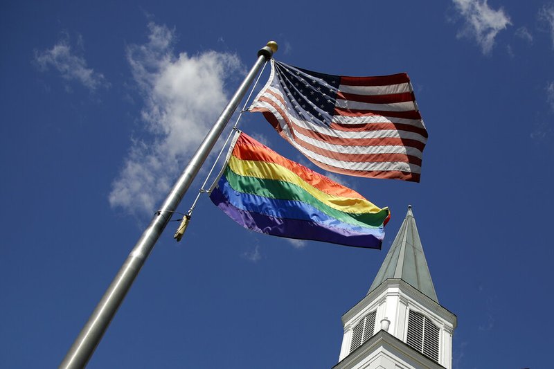 A gay pride rainbow flag flies along with the U.S. flag in front of the Asbury United Methodist Church in Prairie Village, Kan., on Friday, April 19, 2019. There's at least one area of agreement among conservative, centrist and liberal leaders in the United Methodist Church: America's largest mainline Protestant denomination is on a path toward likely breakup over differences on same-sex marriage and ordination of LGBT pastors. (AP Photo/Charlie Riedel)