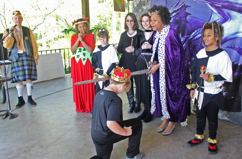 El Dorado Royalty: ‘Queen’ Veronica Smith-Creer, El Dorado mayor, knights young Owen Shaffer at yesterday’s Fellowship of the Spring Renaissance Faire. The queen’s court looks on with glee. Pictured from left to right are Gary Hall, Karma Samuels, Sammy Shaffer, Glenda Lancaster, Haven Lancaster, Veronica Smith-Creer and Daymion Samuels. Owen Shafer is in the foreground, kneeling. Caitlan Butler/News-Times