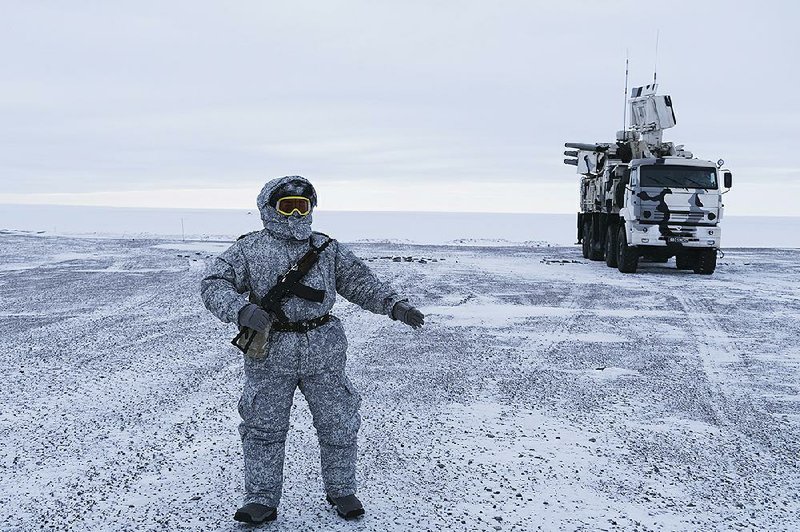 A Russian soldier guards a mobile air defense system on Kotelny Island, between the Laptev Sea and the East Siberian Sea. 