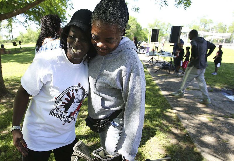 Kim Blackshire-Lee (left) gets a hug from her friend Angela Walton on Saturday during a family picnic in honor of Blackshire-Lee’s son, Bradley Blackshire, who was shot and killed by Little Rock police in February. 