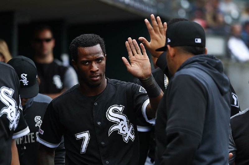 Chicago White Sox's Tim Anderson (7) celebrates scoring against the Detroit Tigers in the sixth inning of a baseball game in Detroit.