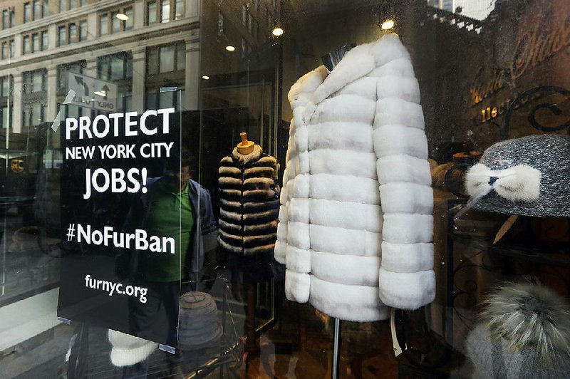 This photo taken in early April shows a sign by furnyc.org in the window of Victoria Stass Collection in New York’s fur district. 