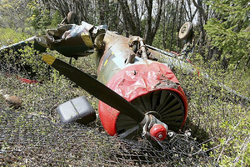 The wreckage of a Nanchang CJ-6 plane is seen Friday after a crash at the Nevada County Airport in Grass Valley, Calif. The plane went over the end of the runway when the pilot was un- able to bring it to a stop. Its two occupants walked away from the crash with minor injuries.  