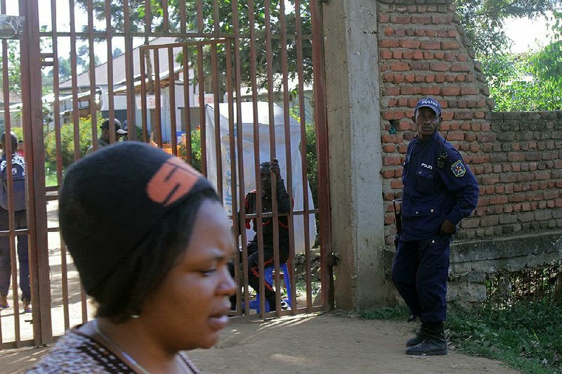 A police officer stands guard Saturday in Butembo, Congo, after the overnight attack on an Ebola treatment center. 