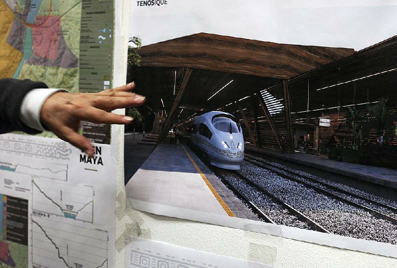 Rogelio Jimenez Pons, director of Fonatur, points to photos of a planned train through the Yucatan Peninsula during an interview in Mexico City last month. 