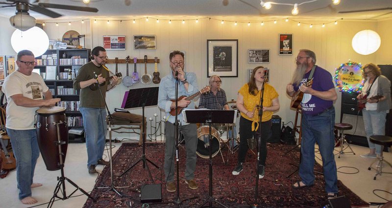 Arkansas Democrat-Gazette/CARY JENKINS The Dogtown Ukulele Band jams out with Michael Rodman (from left), Jason Plaxco, Rick Lee, Joe Roitz, Hannah Moore, Mitch Vire and Deb Moore.