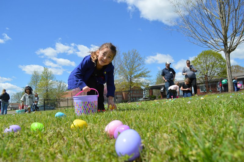 Sierra Bush/Herald Leader Zola Wiles looks to another student as she retrieves her own easter egg during the Friendship Community Care's Easter egg hunt Friday. FCC is a nonprofit organization that serves children with disabilities.