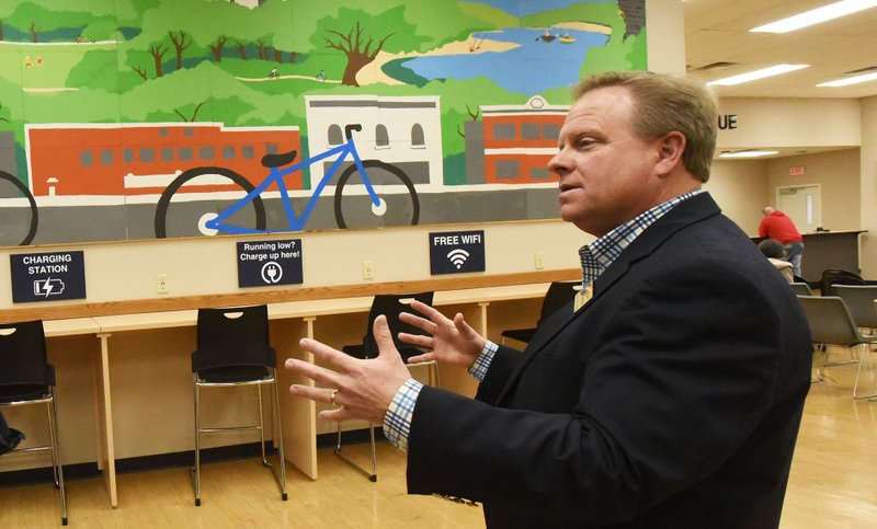 Benton County Judge Barry Moehring talks Wednesday Dec. 19 2018 with Hass Hall Academy Bentonville students who painted a mural that is displayed at the Benton County Rogers Office.