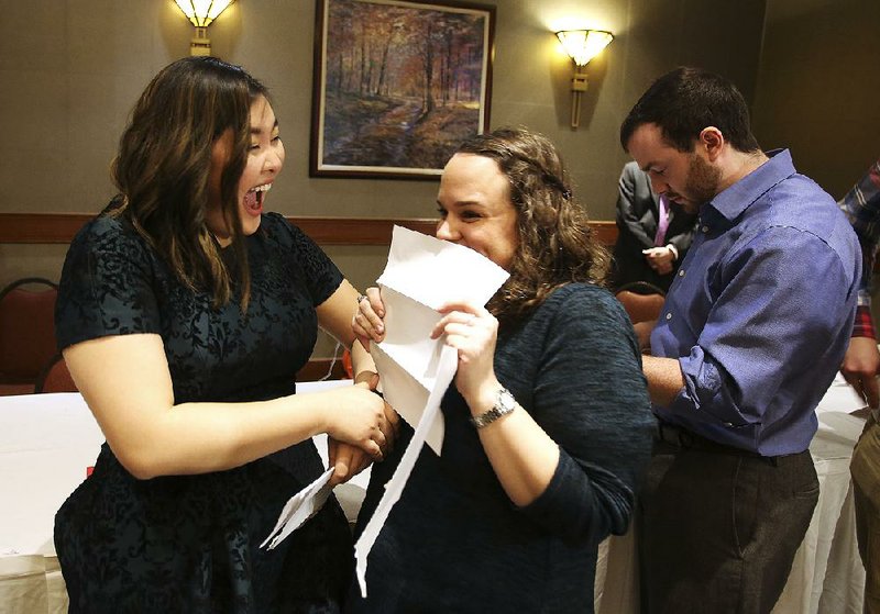 Thanh Dai (left) and Bailey Barnes react after opening their match letters during the University of Arkansas for Medical Sciences’ Match Day on March 16, 2018, at the Embassy Suites in Little Rock. Dai was matched with UAMS and Barnes with the University of Florida. 