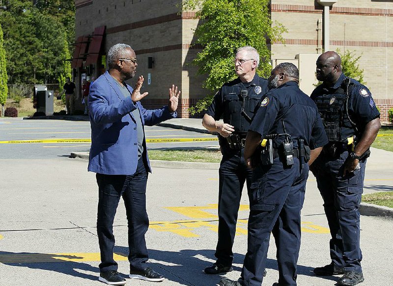 Little Rock Police Chief Keith Humphrey (left) talks to officers after Sunday’s shooting on South Shackleford Road in Little Rock. 