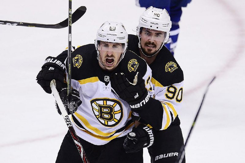 Boston Bruins left wing Brad Marchand (left) celebrates his goal with left wing Marcus Johansson during the first period Sunday against the Toronto Maple Leafs in Toronto. Marchand had two goals and an assist as the Bruins won 4-2 to force a Game 7 in their first-round playoff series.
