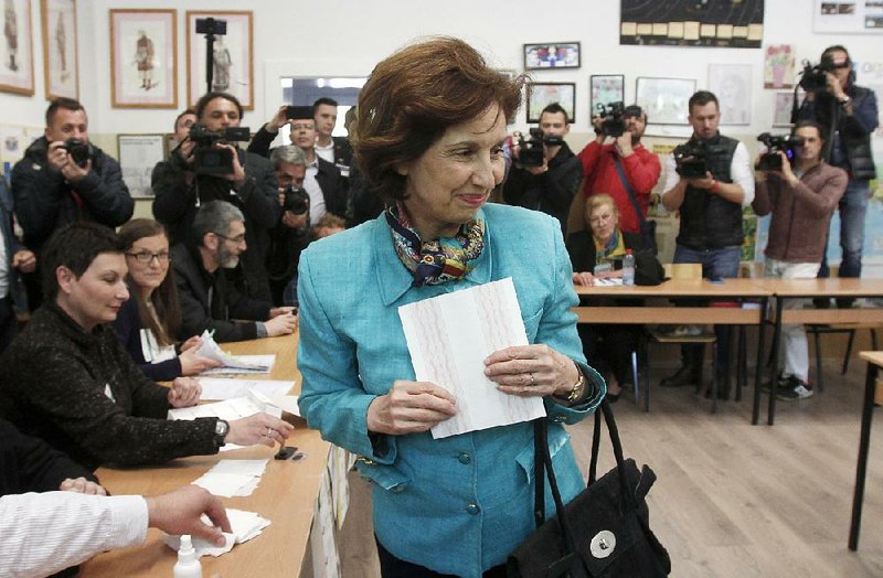 Gordana Siljanovska Davkova, a North Macedonian presidential candidate, holds her ballot Sunday at a polling station in Skopje. Siljanovska Davkova has expressed opposition to the deal that renamed the country. 