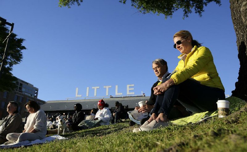 Ashley and Kurt Knickrehm bow their heads in prayer Sunday during the 31st annual Community Easter Sunrise Service in the Little Rock River Market District. More photos are available at arkansasonline.com/422sunrise/ 