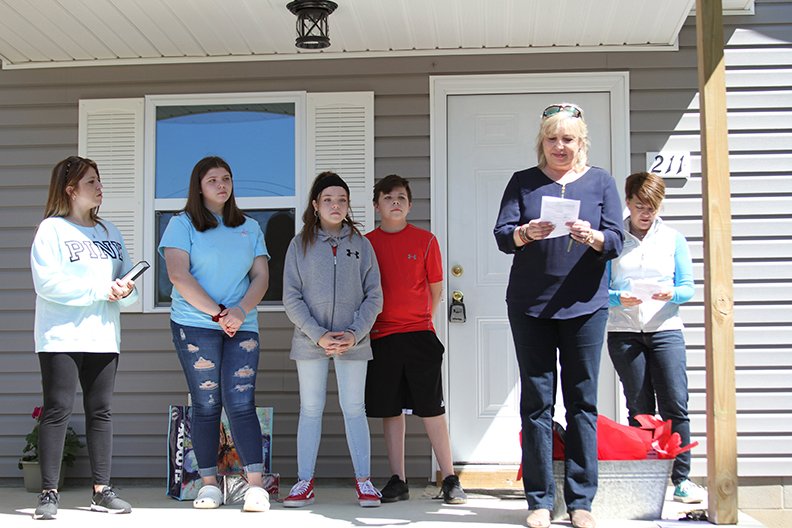 Rhonda Harrington (second on right) and Cindy Wagstaff (Far right) present a Habitat for Humanity house to Sarita Rodrigues (Far Left) and her three children Shyann Jones, Mariah Rodrigues and Hunter Rodrigues at the houses dedication.