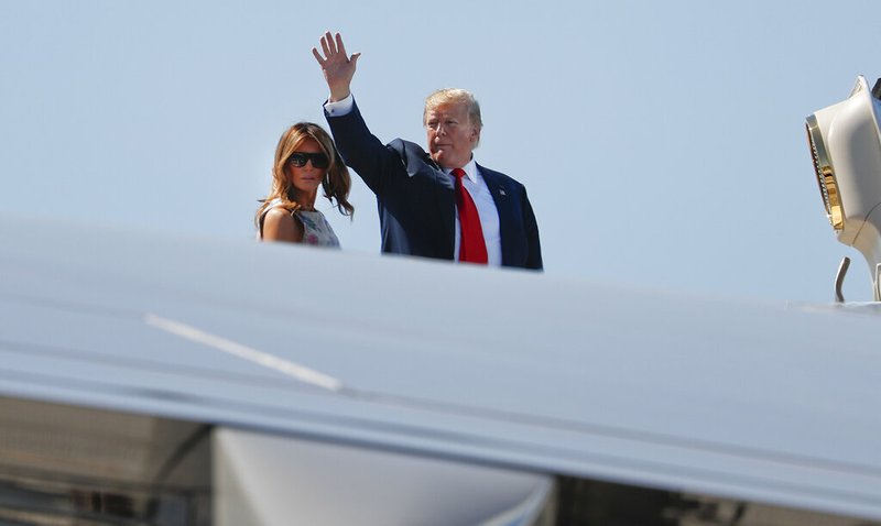 President Donald Trump, right, waves as he and first lady Melania Trump board Air Force One prior to departure from Palm Beach International Airport, Sunday, April 21, 2019, in West Palm Beach Fla. (AP Photo/Pablo Martinez Monsivais)