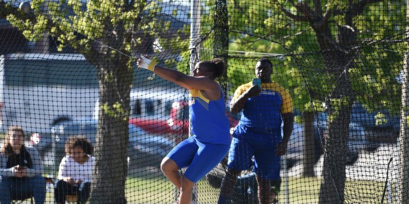 SAU senior T’Keyah Crockett throws the hammer at the GAC Championships, while teammate Sinclair Pitts (background) films her. Both are former Magnolia athletes and claimed first place honors at the GAC meet. Crockett broke the GAC record in the hammer throw.