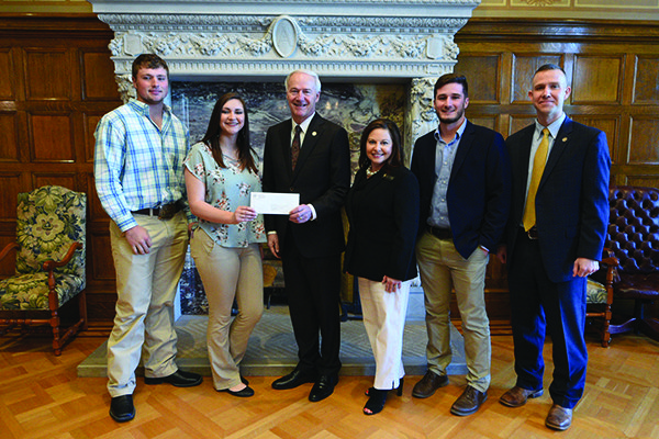 Left to right: Strand Barricklow; Tina Padgett; Gov. Asa Hutchinson; Sheryl Edwards, director of government relations at SAU; Kory Callaway, and Wes Ward, state agriculture secretary.