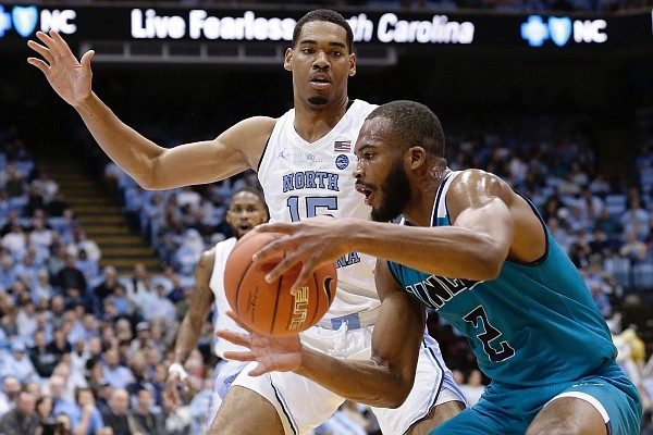 North Carolina's Garrison Brooks (15) guards UNC Wilmington's Jeantal Cylla (2) during the second half of an NCAA college basketball game in Chapel Hill, N.C., Wednesday, Dec. 5, 2018. North Carolina won 97-69. (AP Photo/Gerry Broome)