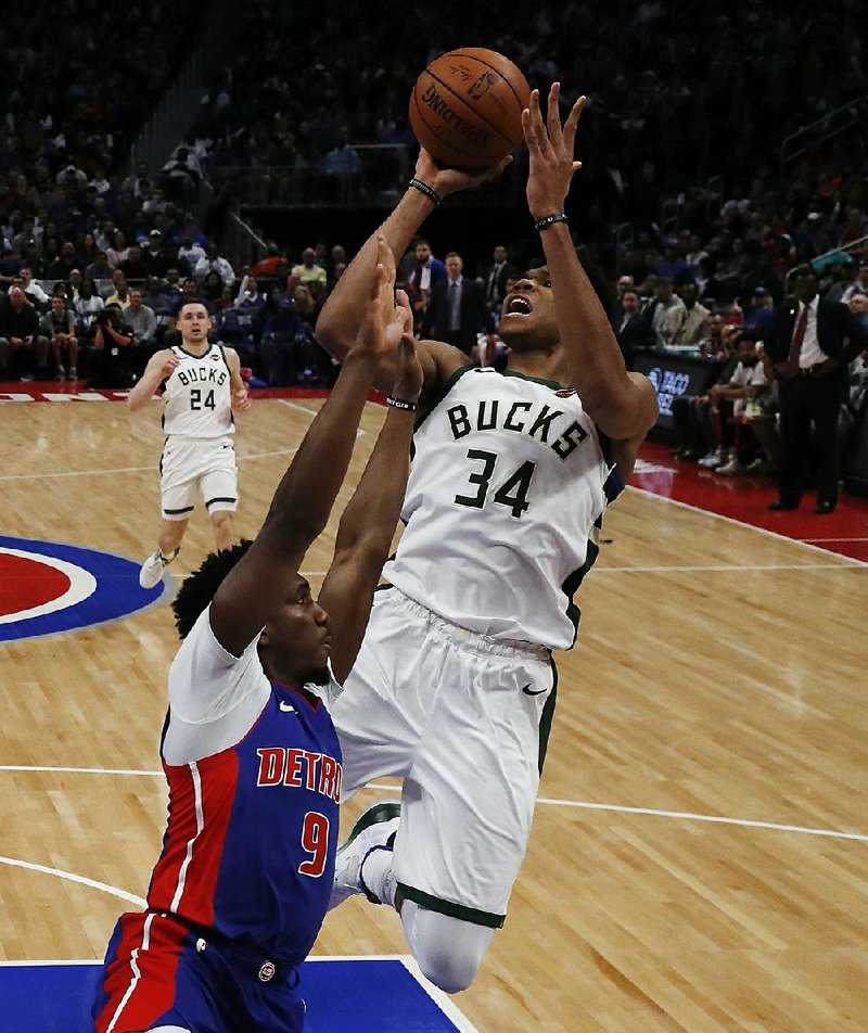 Milwaukee forward Giannis Antetokounmpo shoots as Detroit guard Langston Galloway defends during Game 4 of the teams’ first-round playoff series Monday in Detroit. Antetokounmpo scored 41 points as the Bucks won 127-104 to sweep the series.