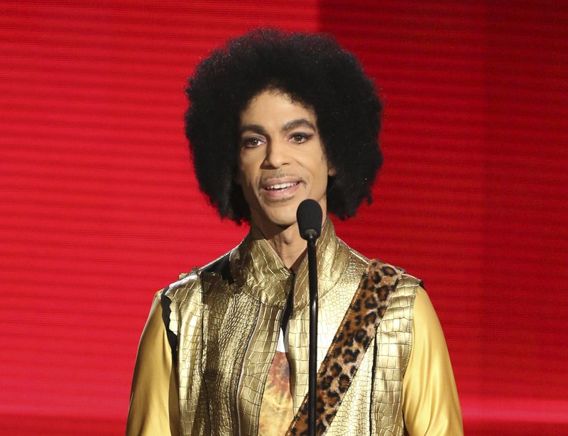 FILE - In this Nov. 22, 2015, file photo, Prince presents the award for favorite album - Soul/R&amp;B at the American Music Awards in Los Angeles. The memoir Prince was working on at the time of his death, &quot;The Beautiful Ones,&quot; is due out in late October 2019. (Photo by Matt Sayles/Invision/AP, File)