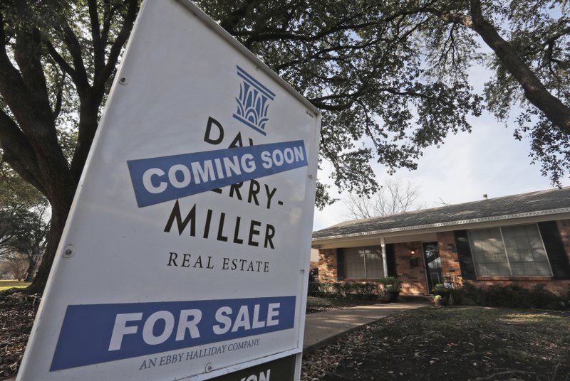 FILE- In this Feb. 20, 2019, file photo a coming soon for sale sign sits in front of a home in the Dallas suburb of Richardson, Texas. On Monday, April 22, the National Association of Realtors reports on sales of existing homes in March. (AP Photo/LM Otero, File)