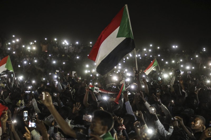 Sudanese protesters use their smartphones' lights during a protest outside the army headquarters in the capital Khartoum on Sunday, April 21, 2019. The organizers of Sudan's protests said Sunday they have suspended talks with the ruling military council because it has failed to meet their demands for an immediate transfer to a civilian government following the overthrow of President Omar al-Bashir.(AP Photo)