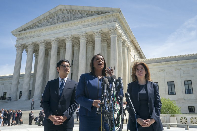 New York State Attorney General Letitia James, center, flanked by Dale Ho, left, an attorney for the American Civil Liberties Union, and New York City Census Director Julie Menin, speaks to reporters after the Supreme Court heard arguments over the Trump administration's plan to ask about citizenship on the 2020 census, in Washington, Tuesday, April 23, 2019. Critics say adding the question would discourage many immigrants from being counted, leading to an inaccurate count. (AP Photo/J. Scott Applewhite)