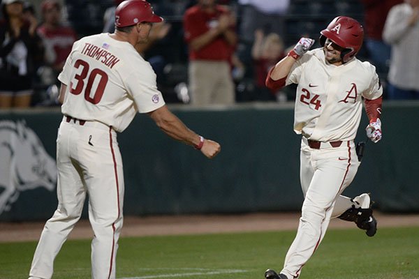 Arkansas center fielder Dominic Fletcher (right) is congratulated by assistant coach Nate Thompson Tuesday, April 23, 2019, after hitting a home run during the seventh inning against Northwestern State at Baum-Walker Stadium in Fayetteville. 