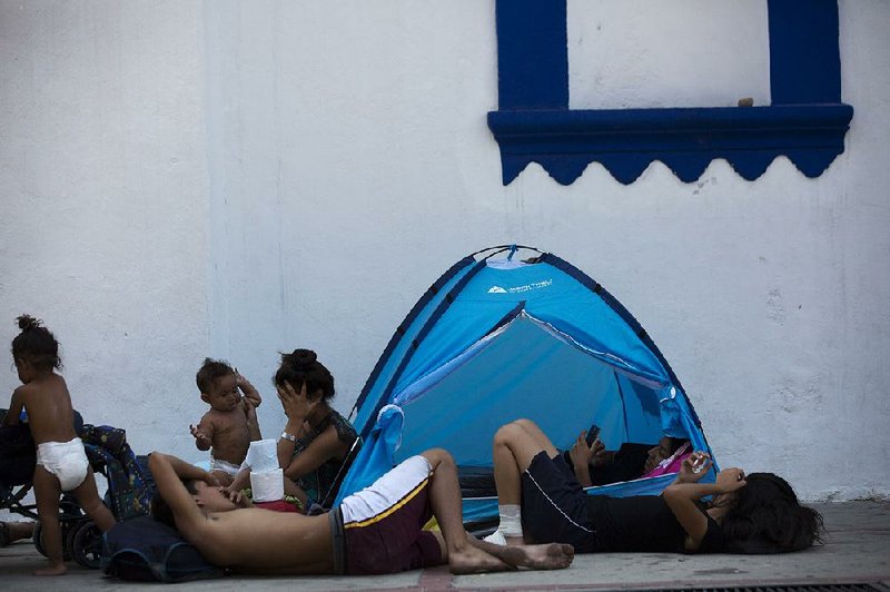 Migrants rest Tuesday at a church in Tonala in Mexico’s Chiapas state. 