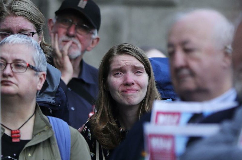 A woman weeps during a Tuesday vigil for slain journalist Lyra McKee in Dublin. 