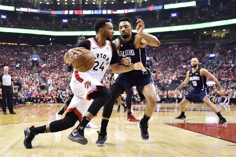 Toronto forward Norman Powell (24) drives to the basket against Orlando center Khem Birch during the Raptors’ 115-96 victory over the Magic on Tuesday in Toronto. Powell finished with 11 points as the Raptors clinched the series. 