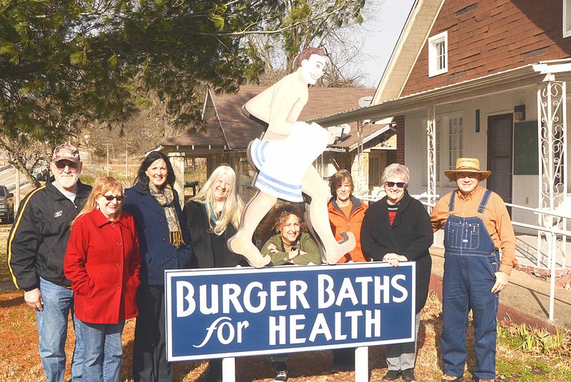 SUBMITTED Commissioners and members of the Community Museum in Sulphur Spring pose with their new replica sign from the 1930s. Pictured (left to right) are Steve Savek, Patty Savek, Katrina Overstreet, Petite Parker, Joyce Young, Margie Sullivan, June Murray and Larry Burge.