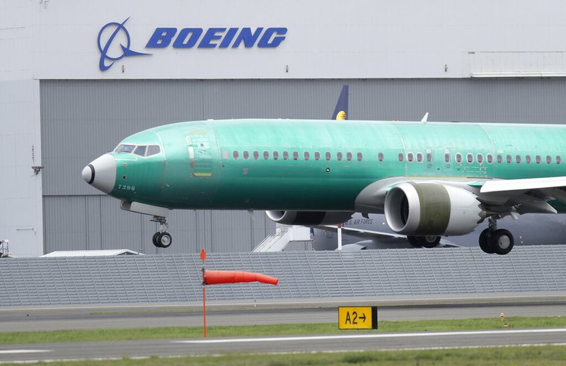 In this April 10, 2019, file photo a Boeing 737 MAX 8 airplane being built for India-based Jet Airways lands following a test flight at Boeing Field in Seattle. Boeing Co. reports earnings Wednesday, April 24. (AP Photo/Ted S. Warren, File)