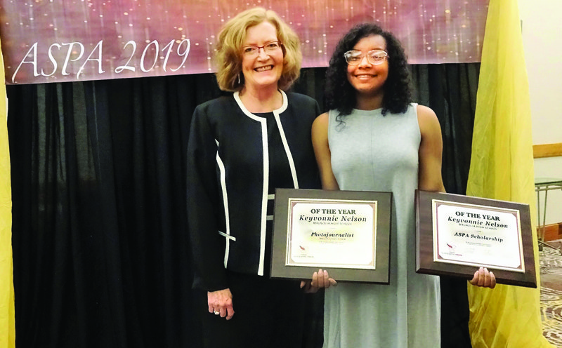 At the annual meeting of the Arkansas Scholastic Press Association April 18-19, Magnolia High student Keyvonnie Nelson was named Photojournalist of the Year and won the organization’s $500 scholarship. Nelson plans to attend University of Central Arkansas in the fall to study journalism. Congratulating her is Connie Hinton, yearbook adviser.