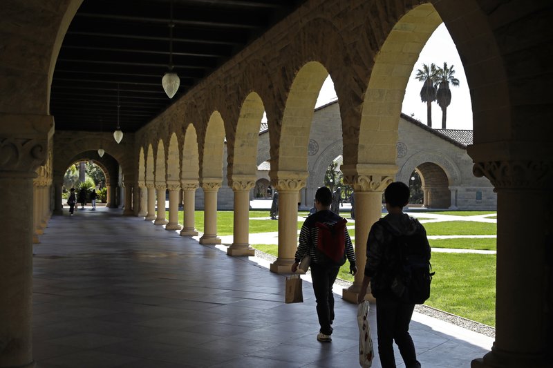 FILE - In this March 14, 2019, file photo, people walk on the Stanford University campus in Santa Clara, Calif. Whether you’re asking your parents for financial help, or they’re offering it, think twice before accepting. If Mom and Dad aren’t on track for retirement, it could end up costing everyone. (AP Photo/Ben Margot, File)


