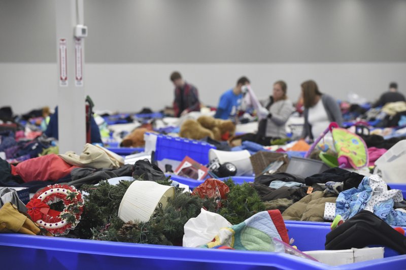In this April 12, 2019, photo shoppers at Goodwill Industries' outlet store find extra deals in rows upon rows of assorted bins in Sturtevant, Wis. (Adam Rogan/The Journal Times via AP)

