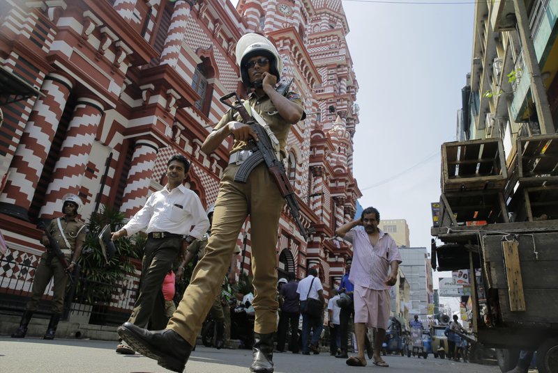 A Sri Lankan police officer patrols out side a mosque in Colombo, Sri Lanka, Wednesday, April 24, 2019. The Islamic State group has claimed responsibility for the Sri Lanka attacks on Easter Sunday and released images that purported to show the attackers. Prime Minister Ranil Wickremesinghe said that investigators were still determining the extent of the bombers' foreign links. (AP Photo/Eranga Jayawardena)