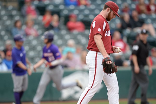 Arkansas closer Matt Cronin reacts Wednesday, April 24, 2019, as Northwestern State right fielder Tyler Smith rounds the bases after hitting a two-run home run during the ninth inning at Baum-Walker Stadium in Fayetteville. Smith finished with three home runs and 7 RBI in a 10-7 win over Arkansas. 